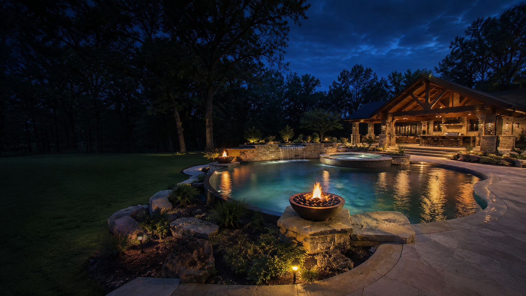 Custom pool, spa, fire features, and outdoor pavilion at twilight